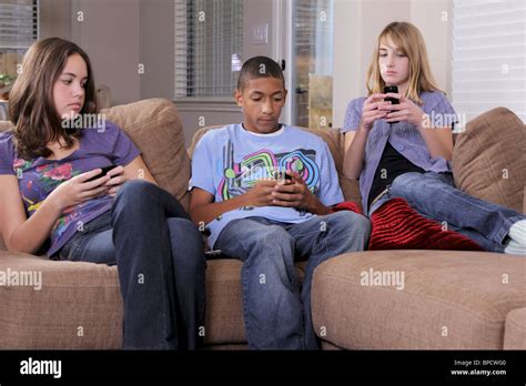 Teens Hanging Out Checking Their Cell Phones Stock Photo Royalty Free