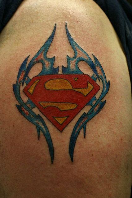 A Superman Tattoo On The Back Of A Mans Shoulder