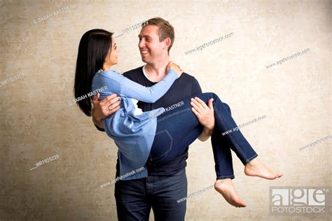 Man Carrying Woman In His Arms Stock Photo Picture And Royalty Free