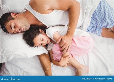 Father Sleeping With Daughter On Bed At Home Stock Image Image Of