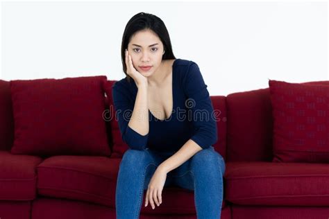 portrait of cute long black hair asian woman sitting on sofa and poses with friendly smile face