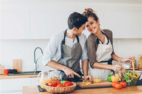 happy couple cooking in kitchen web auburn homes