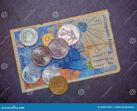 The Vintage Pre Euro French Banknote And Coins On The Black Background