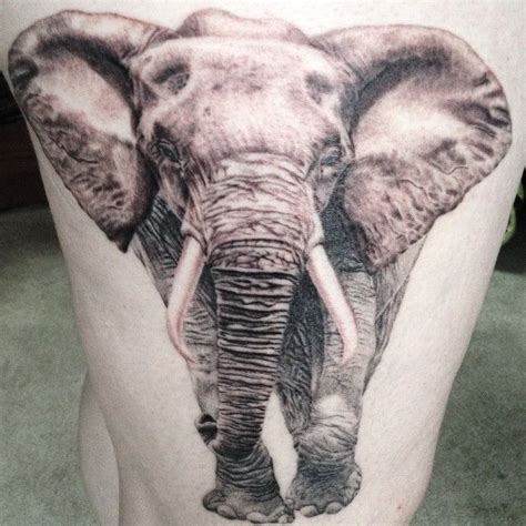 An Elephant Tattoo On The Back Of A Mans Leg Is Shown In Black And White