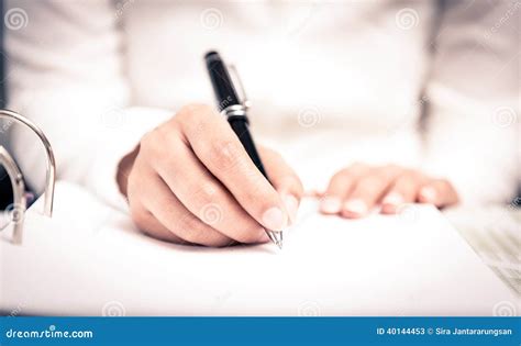 Close Shot Of A Human Hand Writing Something On The Paper Stock Image