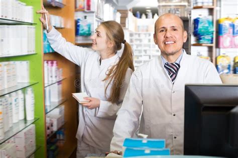 Happy Pharmacist And Pharmacy Technician Helping Stock Photo Image Of