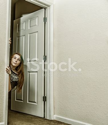 Teenager Girl Peeking Out From Doorway Stock Photo Royalty Free Freeimages