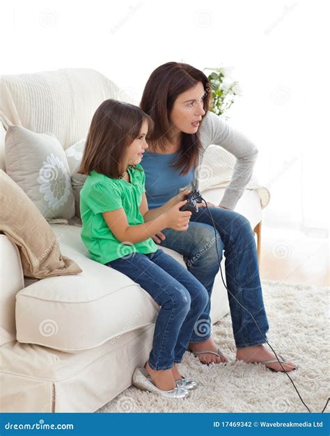 Concentrated Mom And Daughter Playing Video Games Stock Photo Image