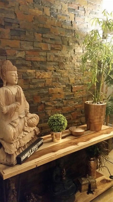We offer buddha statues of all shapes and sizes. Indonesian mango wood entry way table with black iron legs. placed infront of a slate stone wall ...