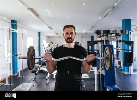 Young Man Doing Biceps Curl With Bar Bar Exercise Concept Of Health