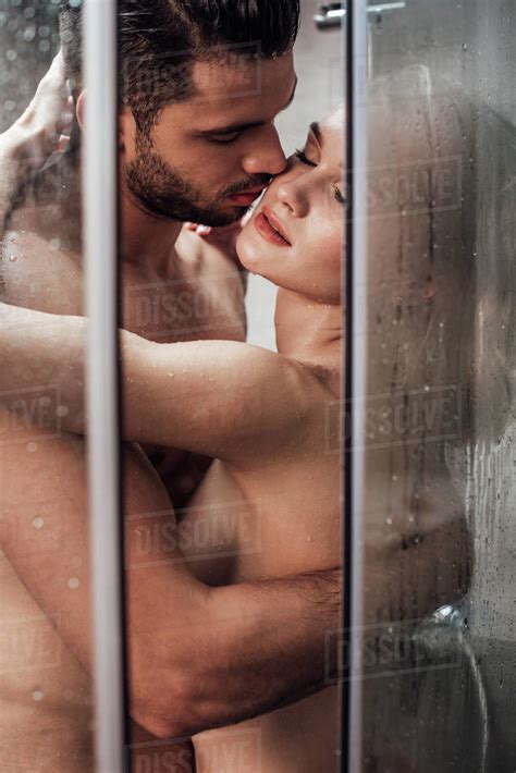 Passionate Naked Couple Hugging And Kissing While Taking Shower