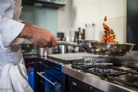 Chef Holding Frying Pan Cooking Food Over Stove Closeup High Res Stock