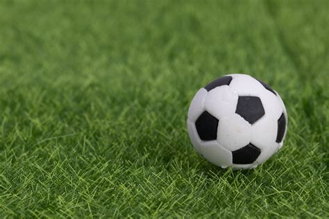 soccer field tactics on a board with soccer ball and referee cards on green grass creative