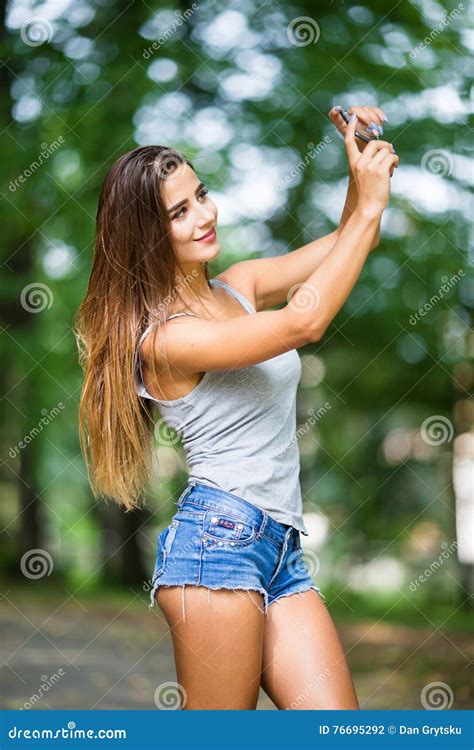 Outdoor Portrait Of Beautiful Girl Taking A Selfie With Mobile Phone