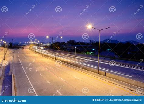 Car Light Trails On Motorway With Beautiful Sky At Twilight Stock Photo