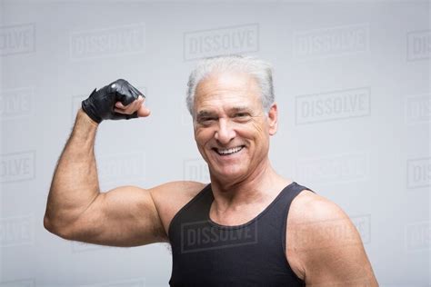 Senior Man Flexing Muscle Portrait Stock Photo Dissolve