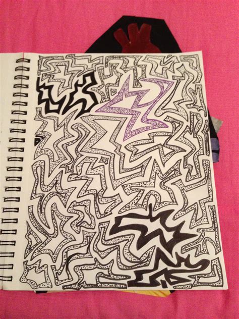 A Notebook With Graffiti On It Sitting On A Pink Surface Next To A