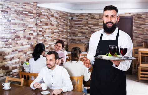 Waiter Welcoming Guests In Restaurant Stock Photo Image Of Adult