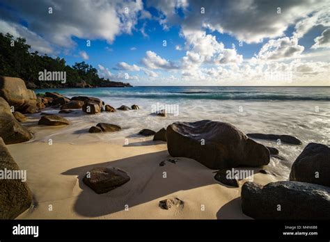 Beautiful Sunset At Paradise Tropical Beach With Granite Rocks And
