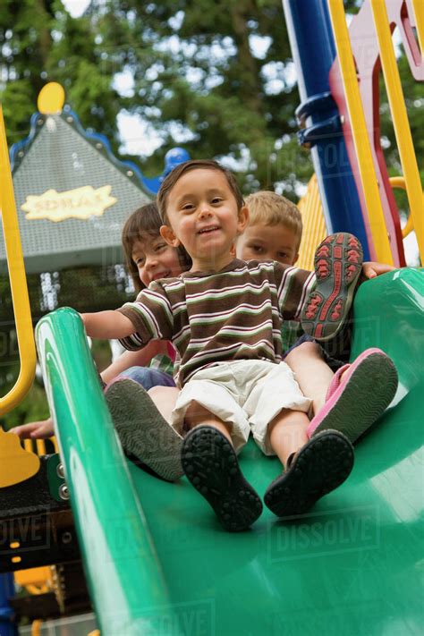 Children Sliding In Playground Stock Photo Dissolve