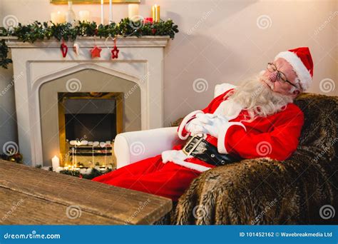 Santa Claus Relaxing On Sofa In Living Room At Home Stock Photo Image