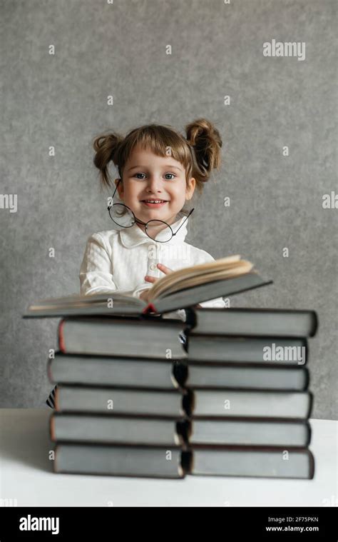 Happy Funny Baby Girl In Glasses Reading A Book Emotional Girl To