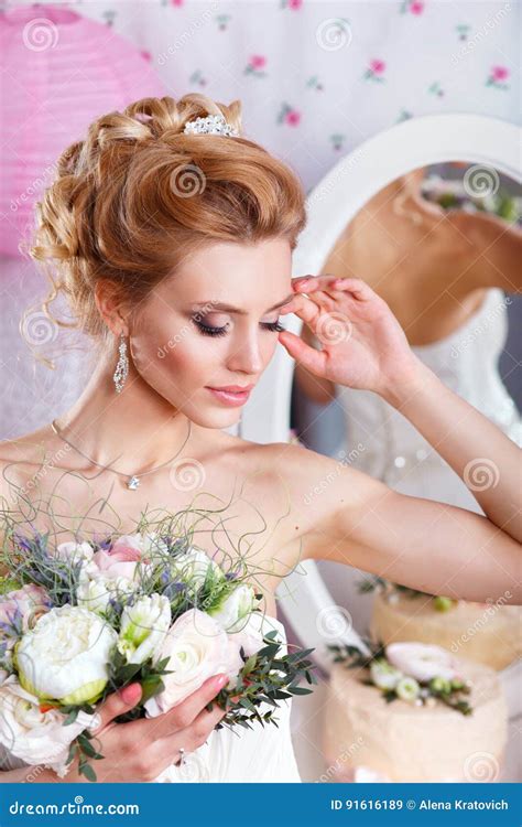 Beautiful Bride With Fashion Wedding Hairstyle And Bouquet Closeup