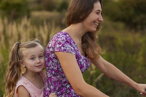 Mom Rides Her Daughter On A Bike Stock Image Image Of Nature