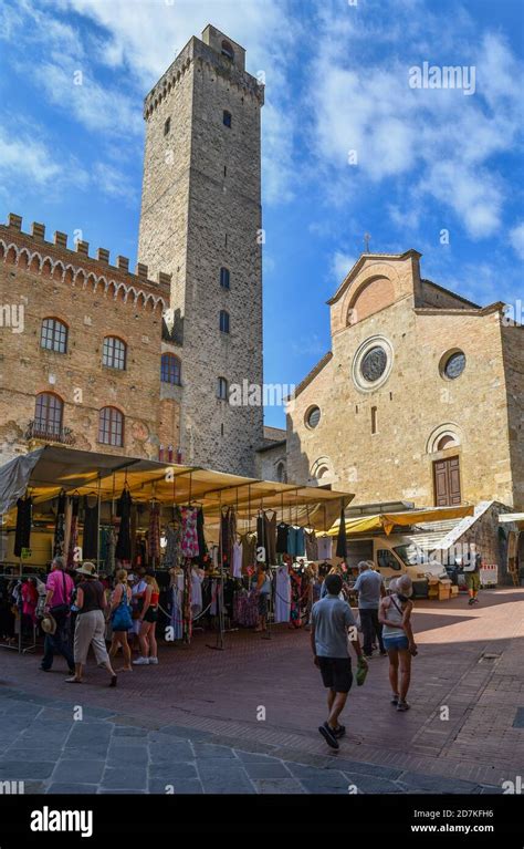 piazza del duomo with the torre grossa and the cathedral duomo in a market day with people and