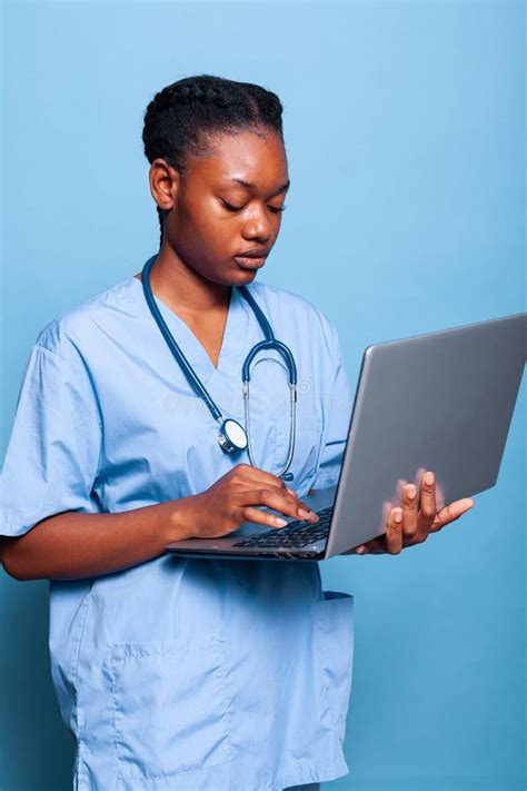 African American Practitioner Nurse Holding Laptop Computer Typing