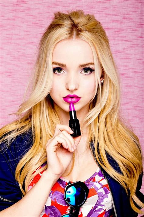 A Woman With Long Blonde Hair Holding A Pink Lipstick