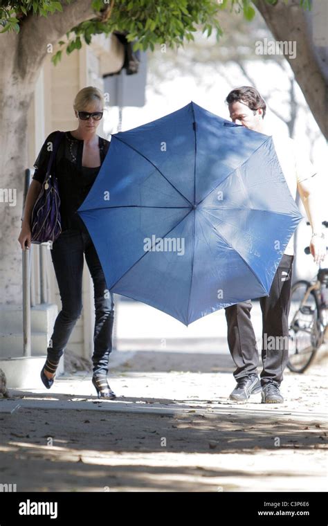 Charlize Theron Leaves A Gym With Her Personal Trainer Who Attempts To