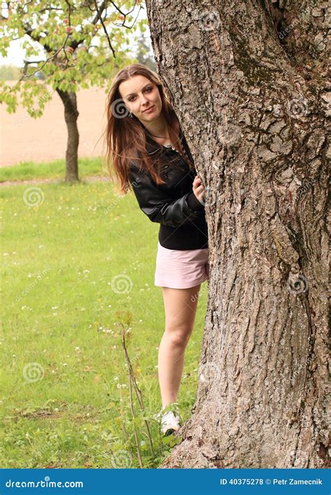 Girl Hiding Behind Tree
