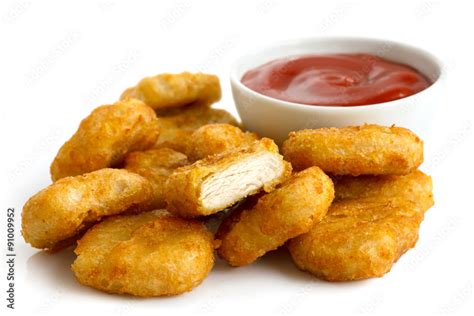 Pile Of Golden Deep Fried Battered Chicken Nuggets With Bowl Of Stock