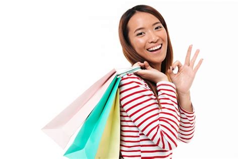 Free Photo Portrait Of A Cheerful Asian Girl Holding Shopping Bags