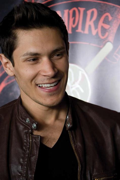 A Smiling Man Wearing A Brown Leather Jacket