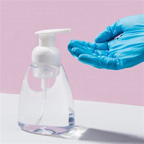 Premium Photo Hand With Surgical Glove Using Hand Sanitizer