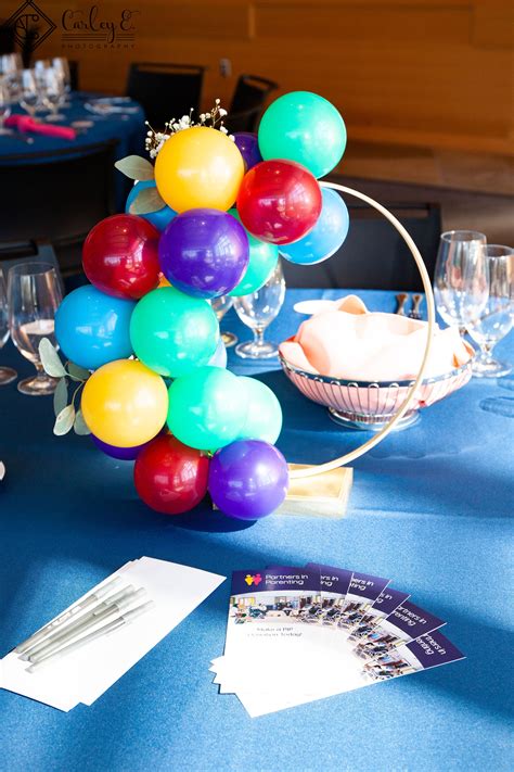 Mini Balloons Wrapped Around A Gold Ring With Greenery Unique Table