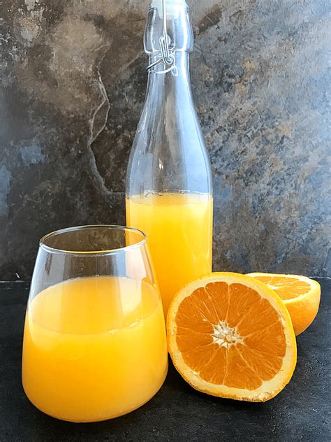 Orange Juice In A Swing Bottle A Glass Cup An Orange Fruit Sliced In