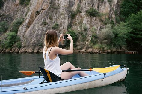 Woman Kayaking And Taking Photos By Stocksy Contributor Ani Dimi