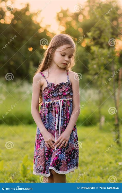 Cute Smiling Little Girl On The Meadow At The Farm Portrait Of