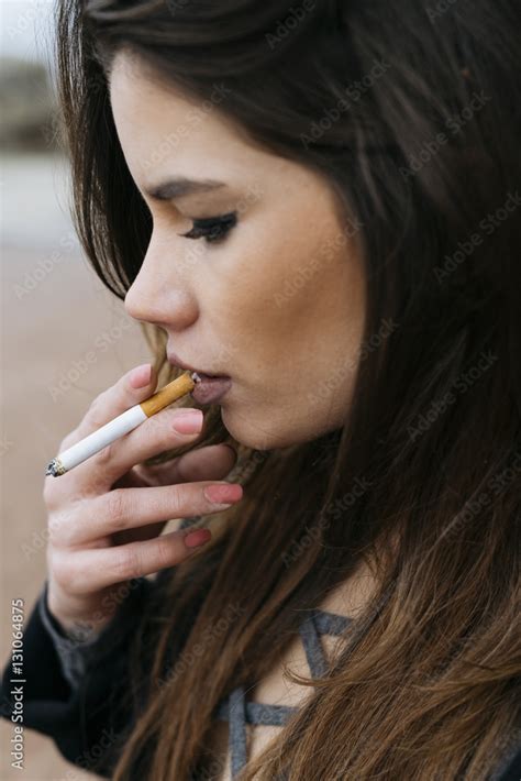 Woman Holding Cigarette To Mouth Photos Adobe Stock