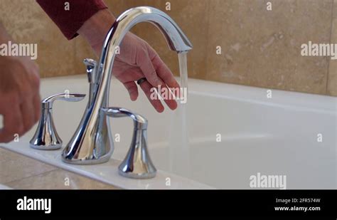 A Man Turns The Hot Water Off In The Bath Tub Stock Video Footage Alamy