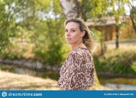 Woman In Her Forties Outside With Green Leaves Stock Photo Image Of