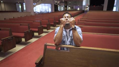 Black Man On His Knees In The Pews In A Church Praying To God Slow
