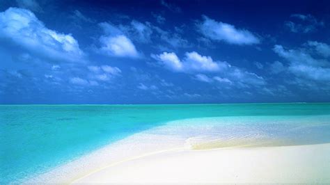Blue Sky Over Turquoise Ocean And White Sand