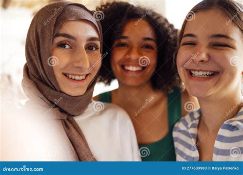 Close Up Portraits Of Three Smiling Teenage Girls Muslim In A Hijab