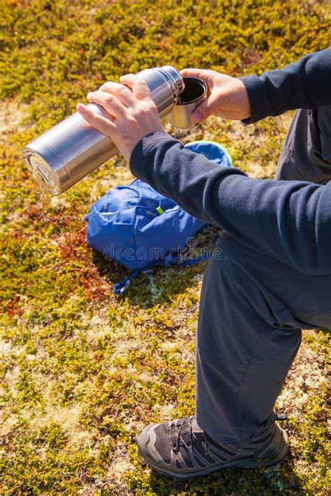 Man Holding Thermos With Hot Tea Outdoors Hiking And Leisure Stock