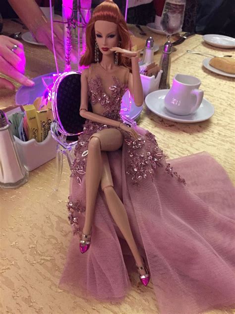 A Barbie Doll Sitting On Top Of A Table