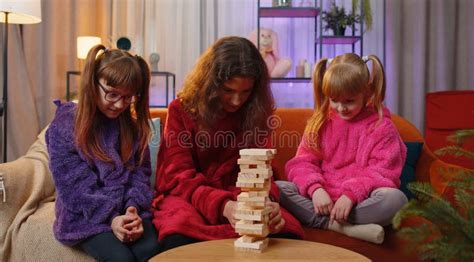 Three Siblings Children Girls Playing With Blocks Board Game Build